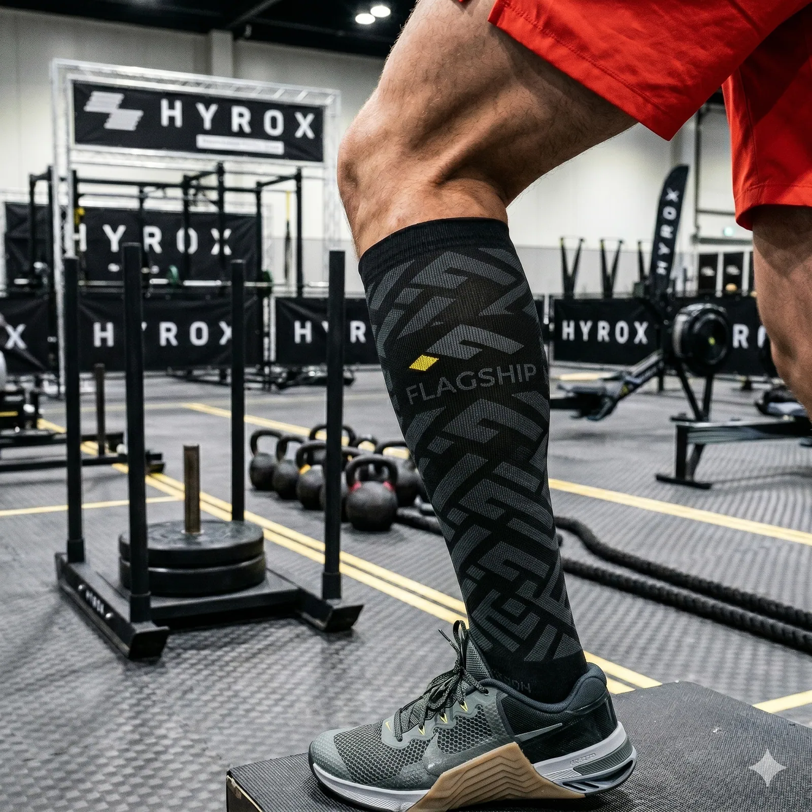 Custom-branded knee-high compression sock at a Hyrox training event